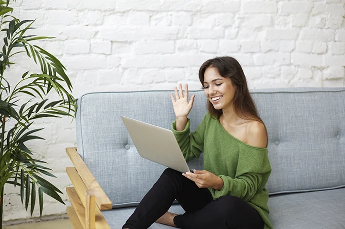 Woman joining an online session from home, representing online somatic awareness and integrative hypnotherapy support.