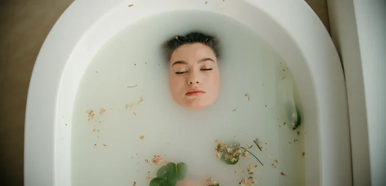 Woman floating in water, symbolizing healing beneath the surface and trauma-informed somatic work.