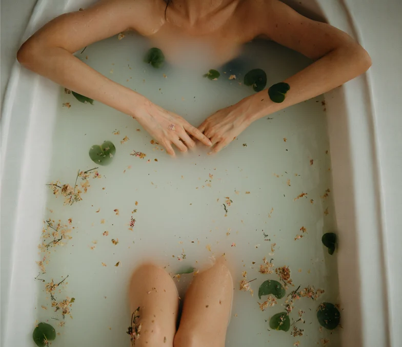 Body resting in water with natural elements, representing psychosomatic symptoms and the mind-body connection.