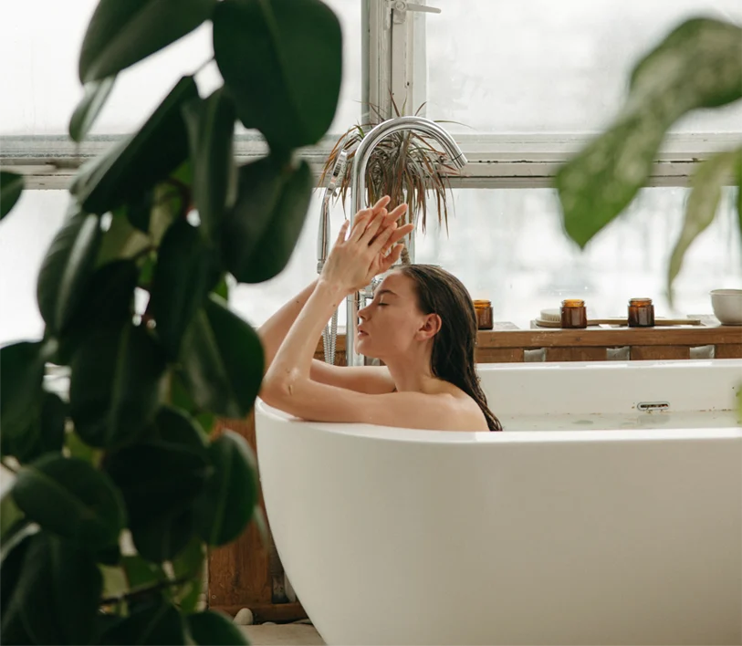 Woman in a quiet bath setting, symbolizing the limits of willpower and the need for nervous system regulation.